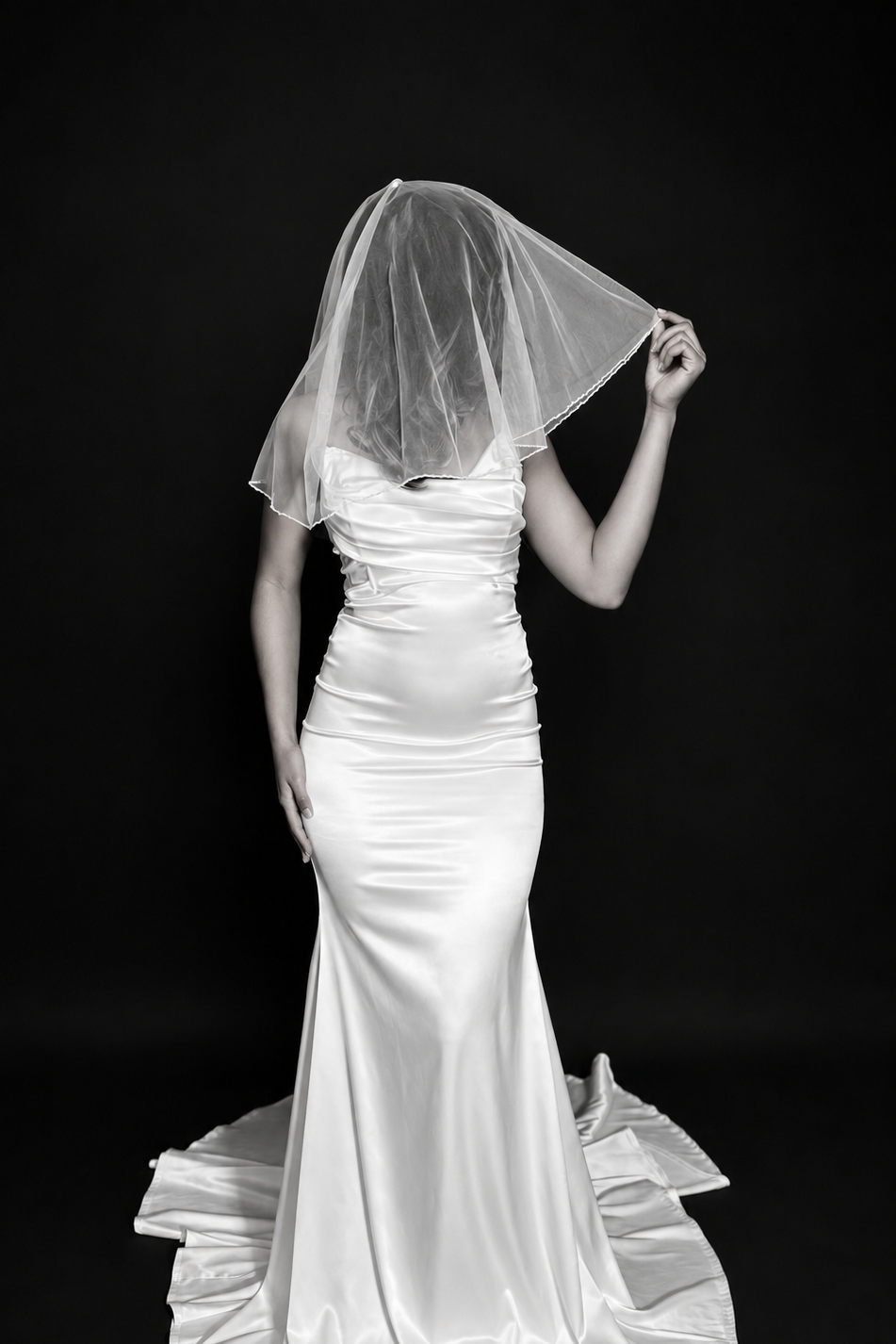 Bride wearing chic shoulder length drop veil with petite pearl beads on the entire trim. The Luna veil is now available, exclusively at The White Veil. 